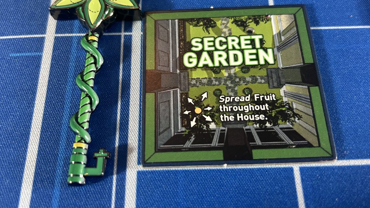 The green flower-and-vine Secret Garden Key beside the Secret Garden tile