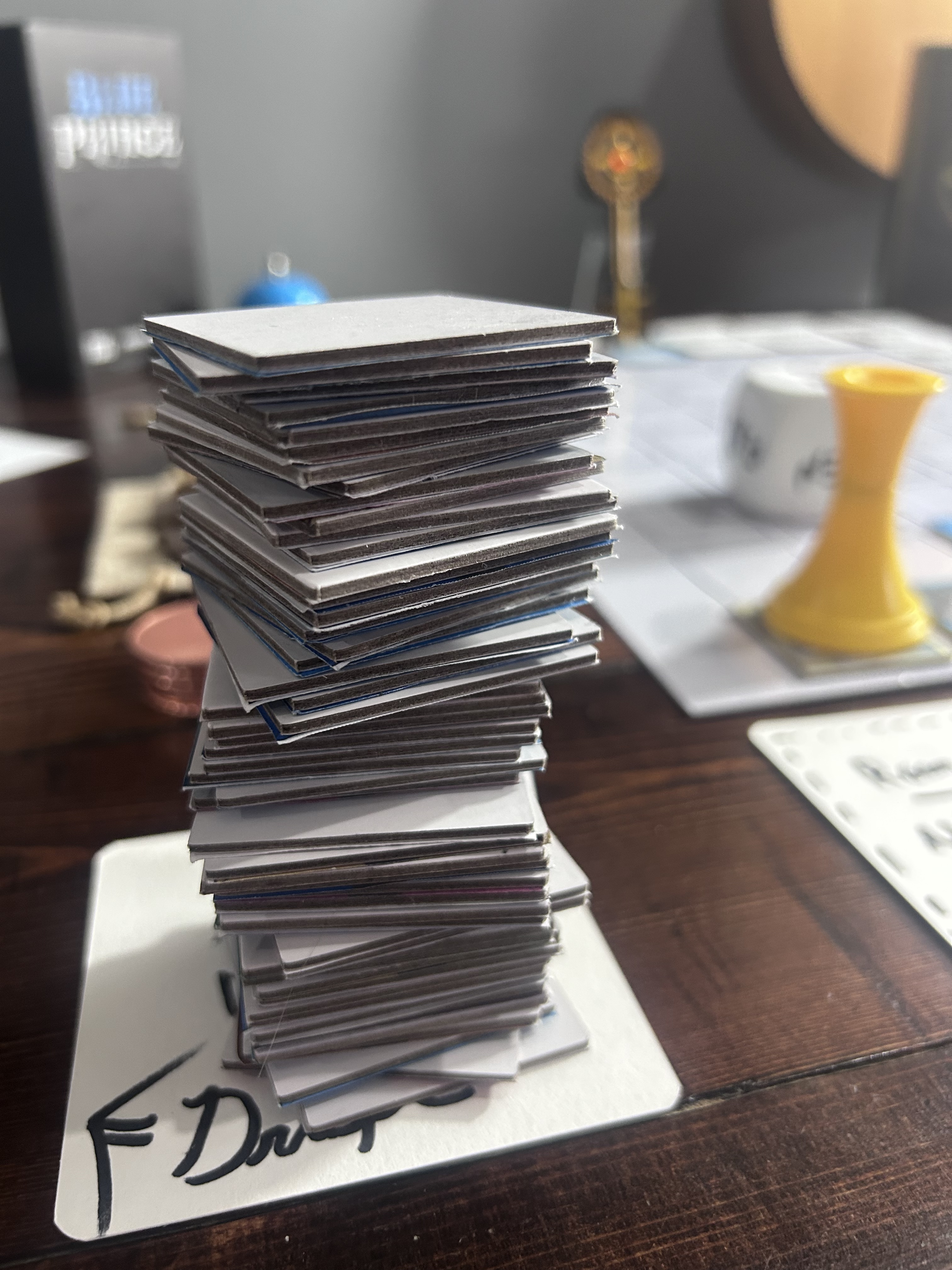 The tile stack at full height — precarious, leaning, face-down backs visible