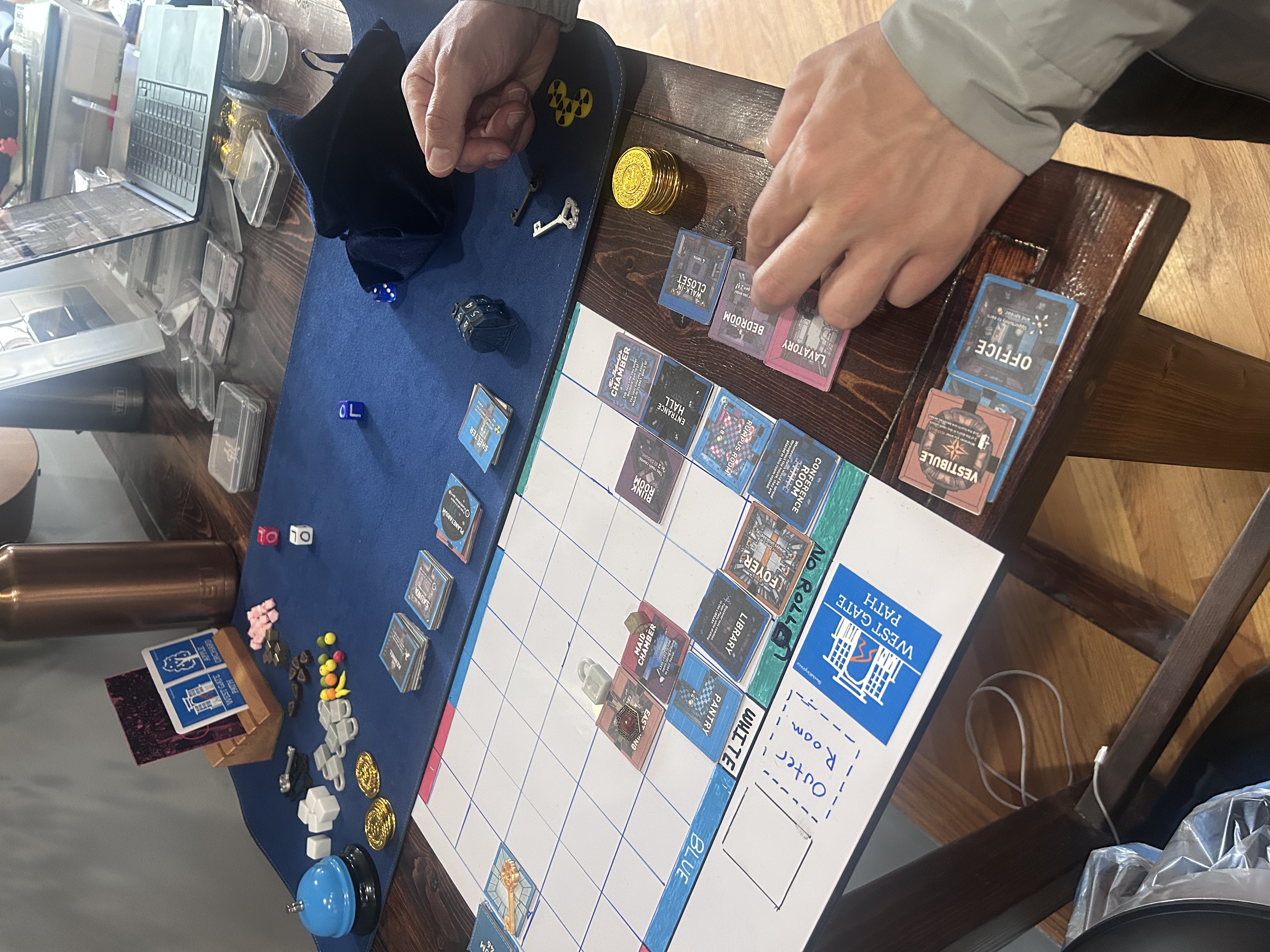 Overhead shot of Mike placing room tiles during the May 9 playtest session
