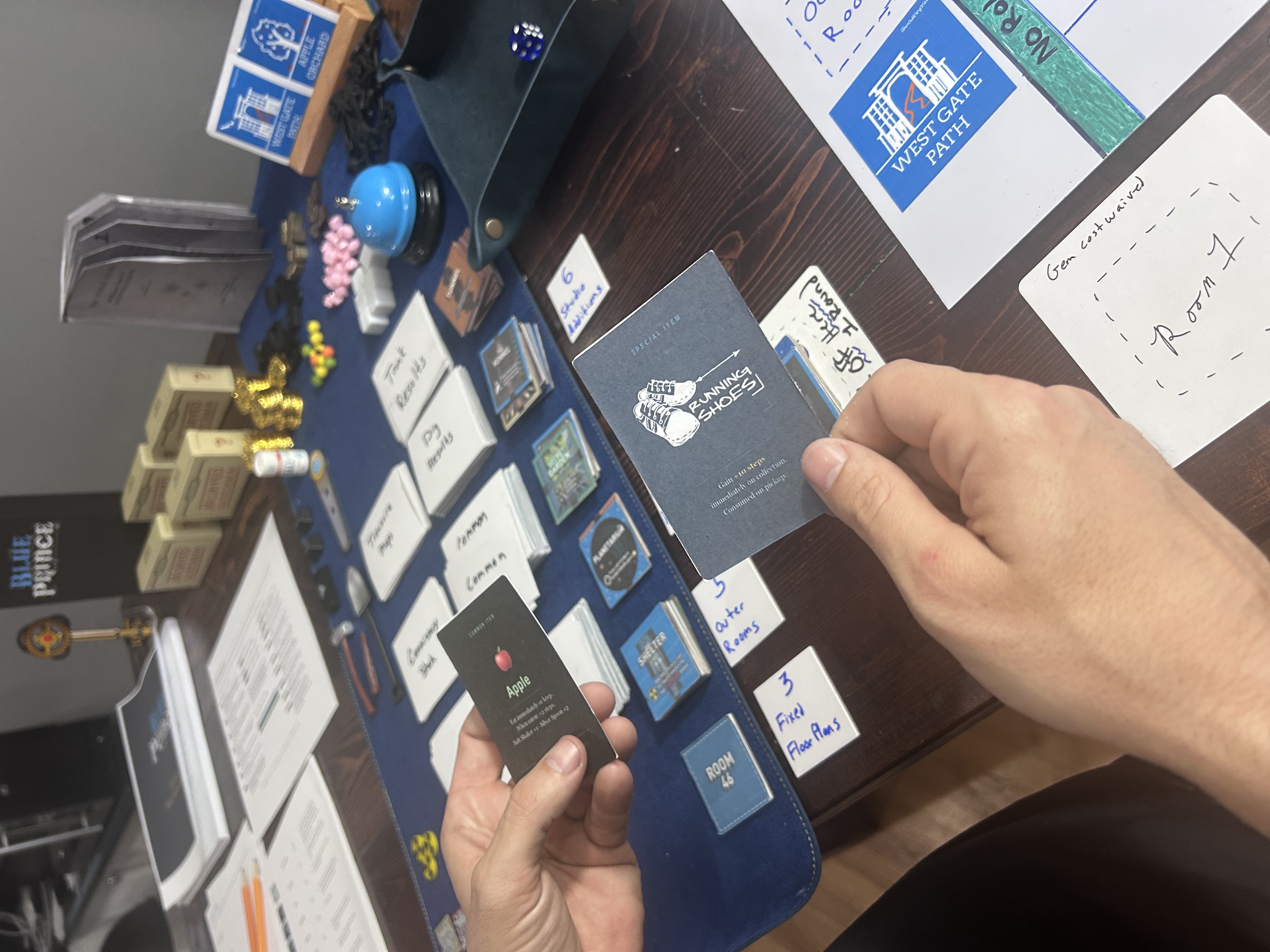 Hands holding an Apple item card and Running Shoes special item card at the table