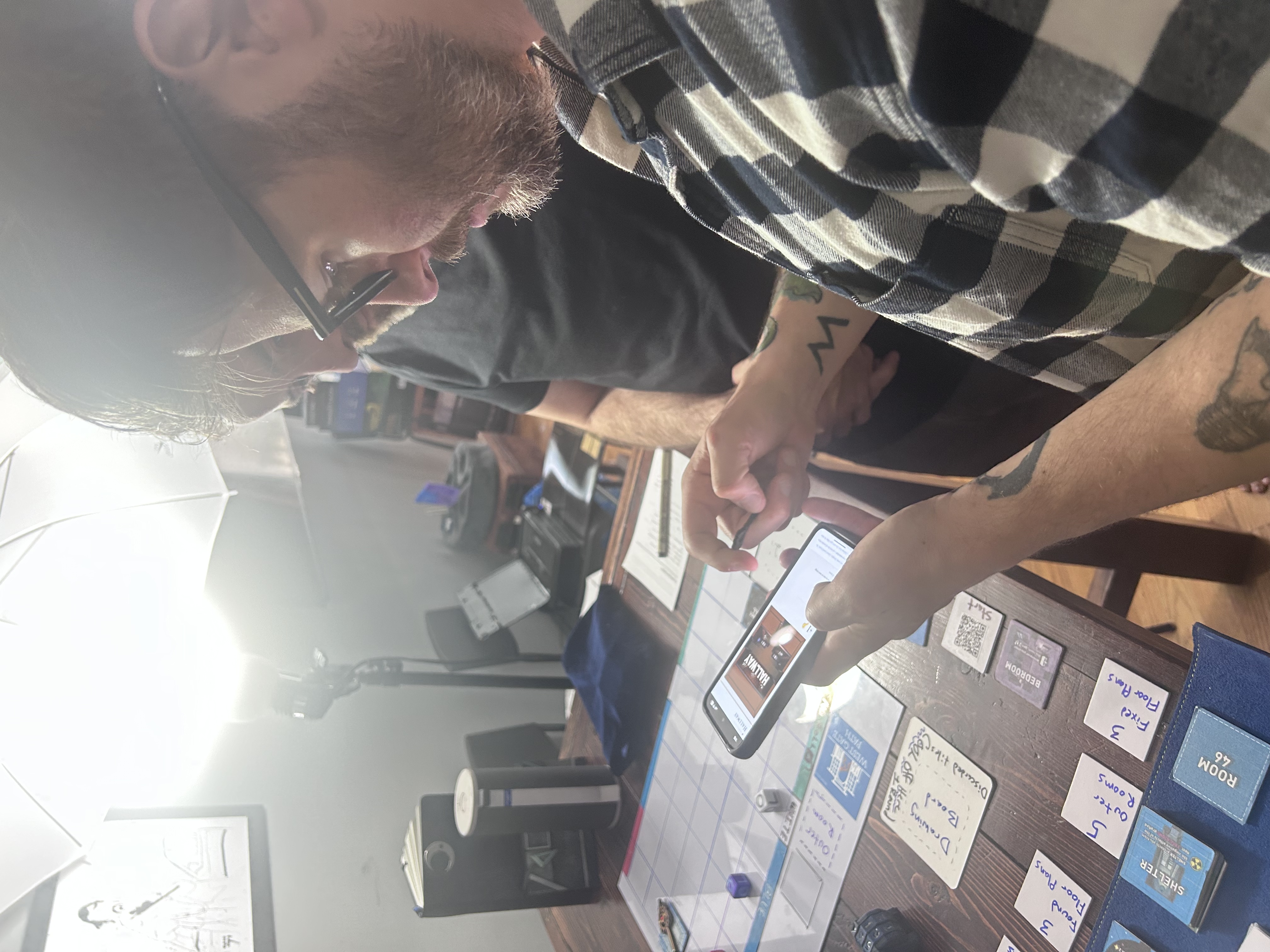 Mike reading the Hallway room landing page on his phone during the session