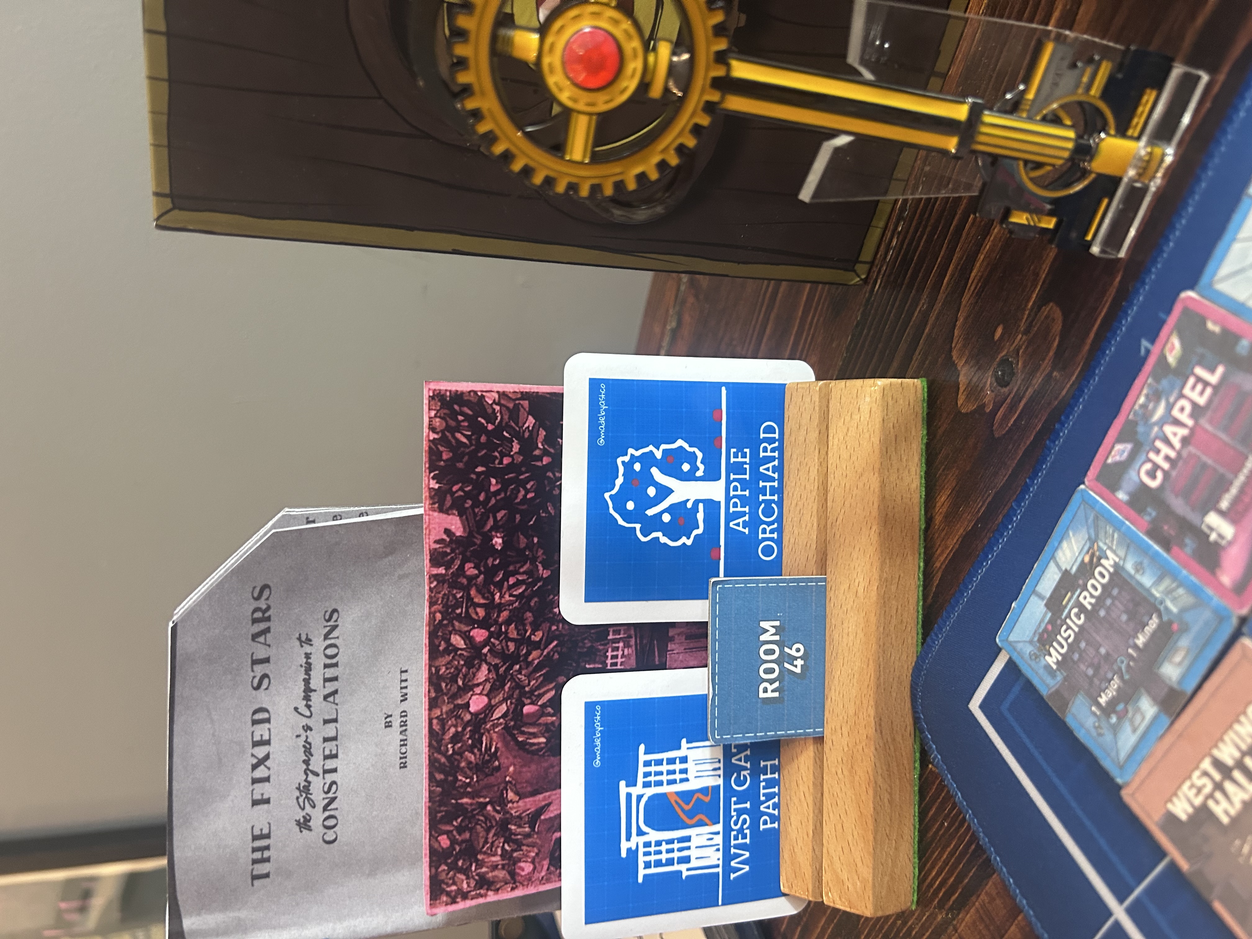 Four Archived Keychain boxes from iam8bit with Prism Key prop, salt shaker, and tools on the mat