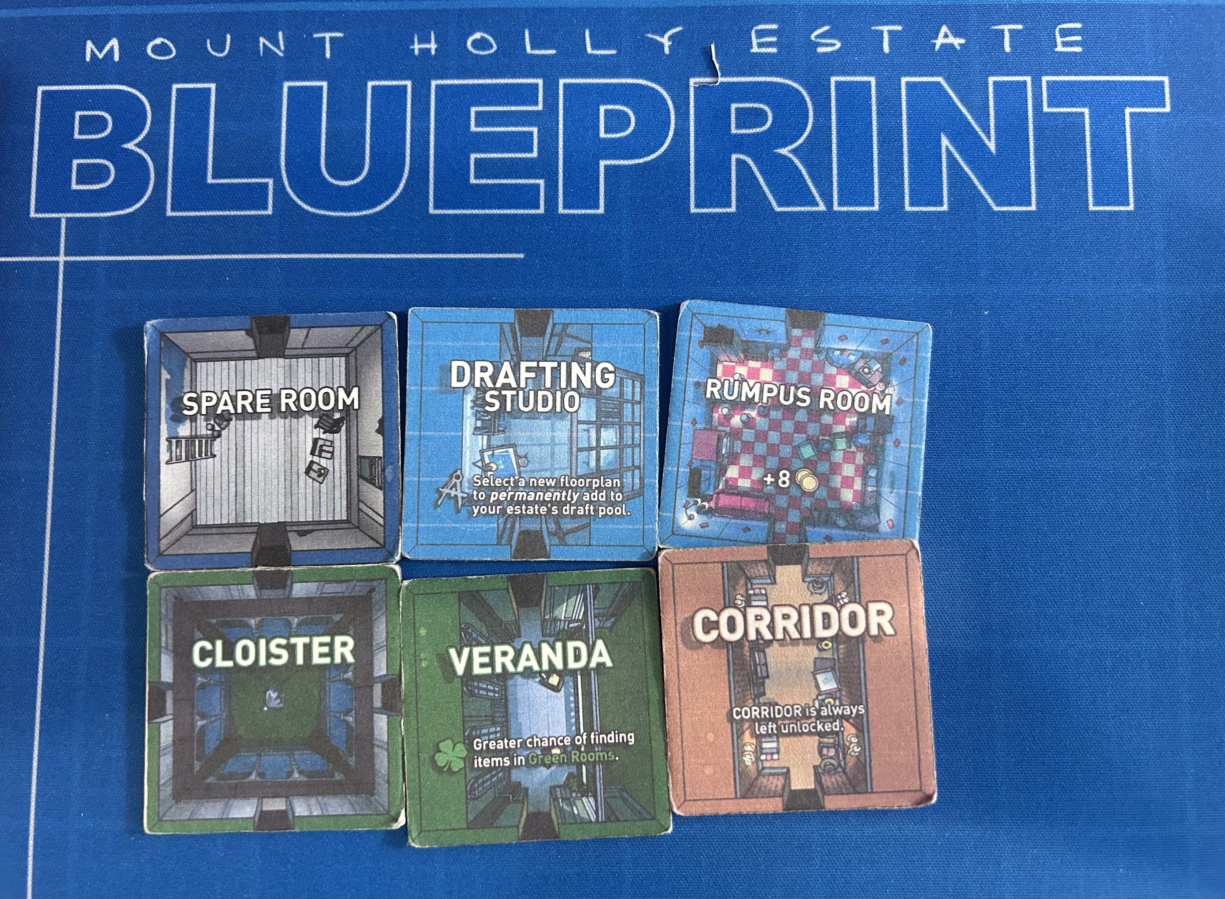Six prototype room tiles laid out on the Blue Prince blueprint board