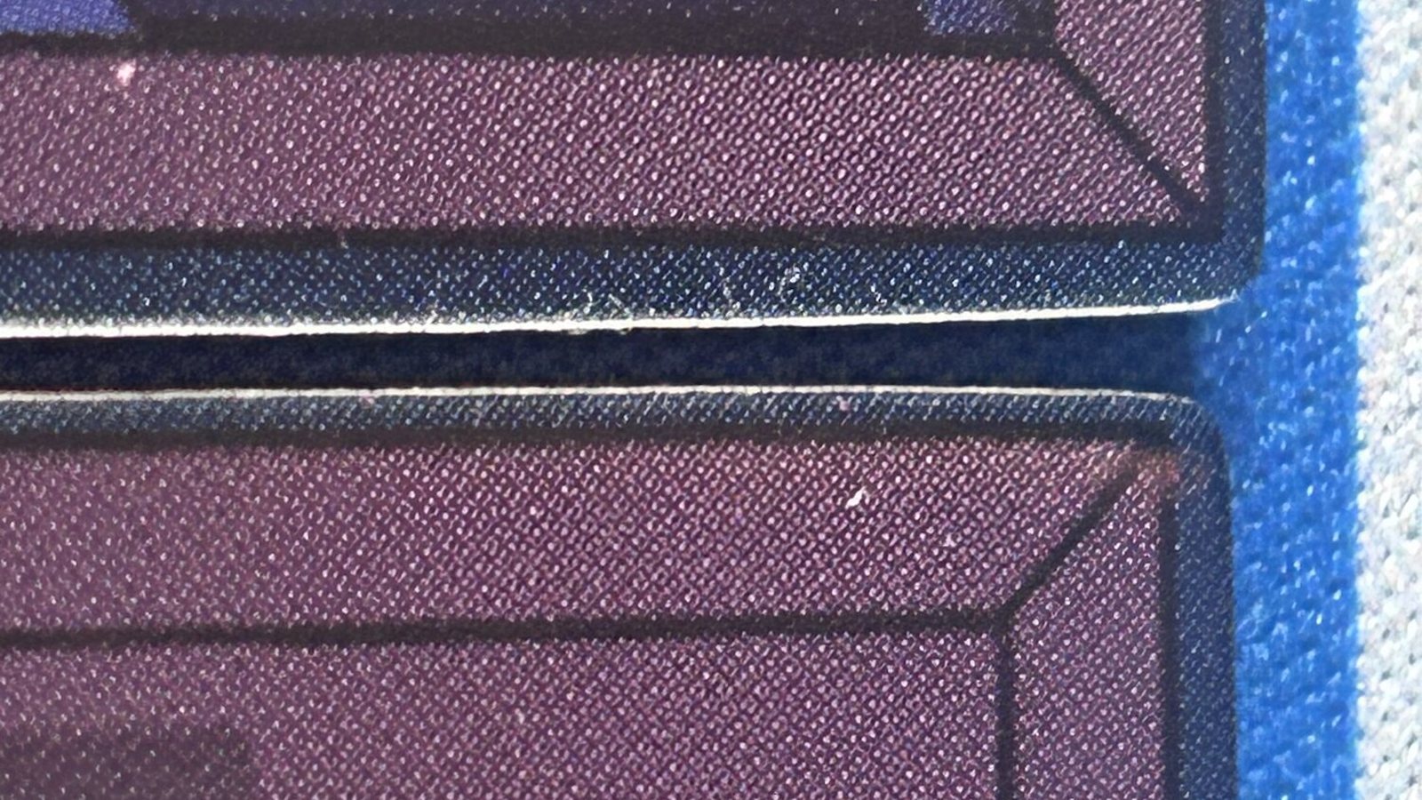 Two purple tiles butted together; the blue rim shows as a dark line where the frames meet