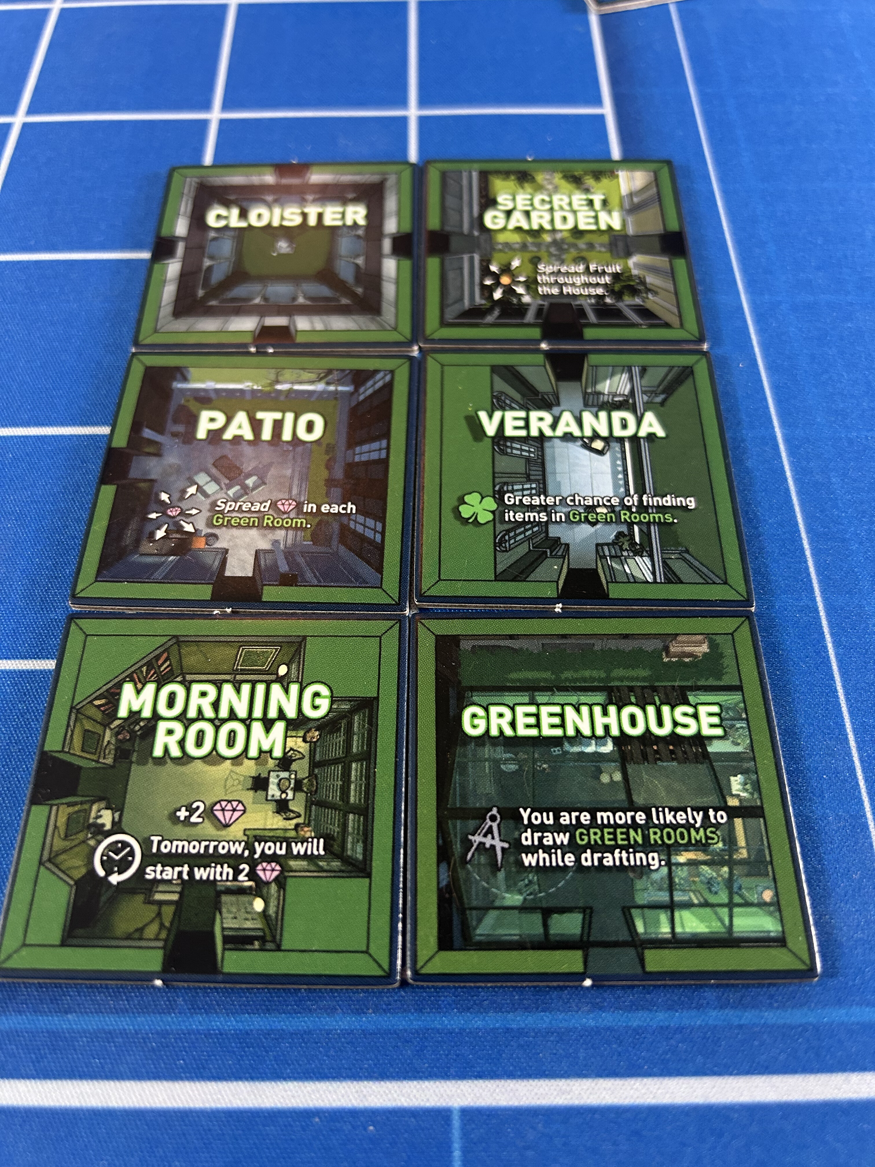 Six Green Room tiles arranged in a grid: Cloister, Secret Garden, Patio, Veranda, Morning Room, and Greenhouse, each with rules text on the tile