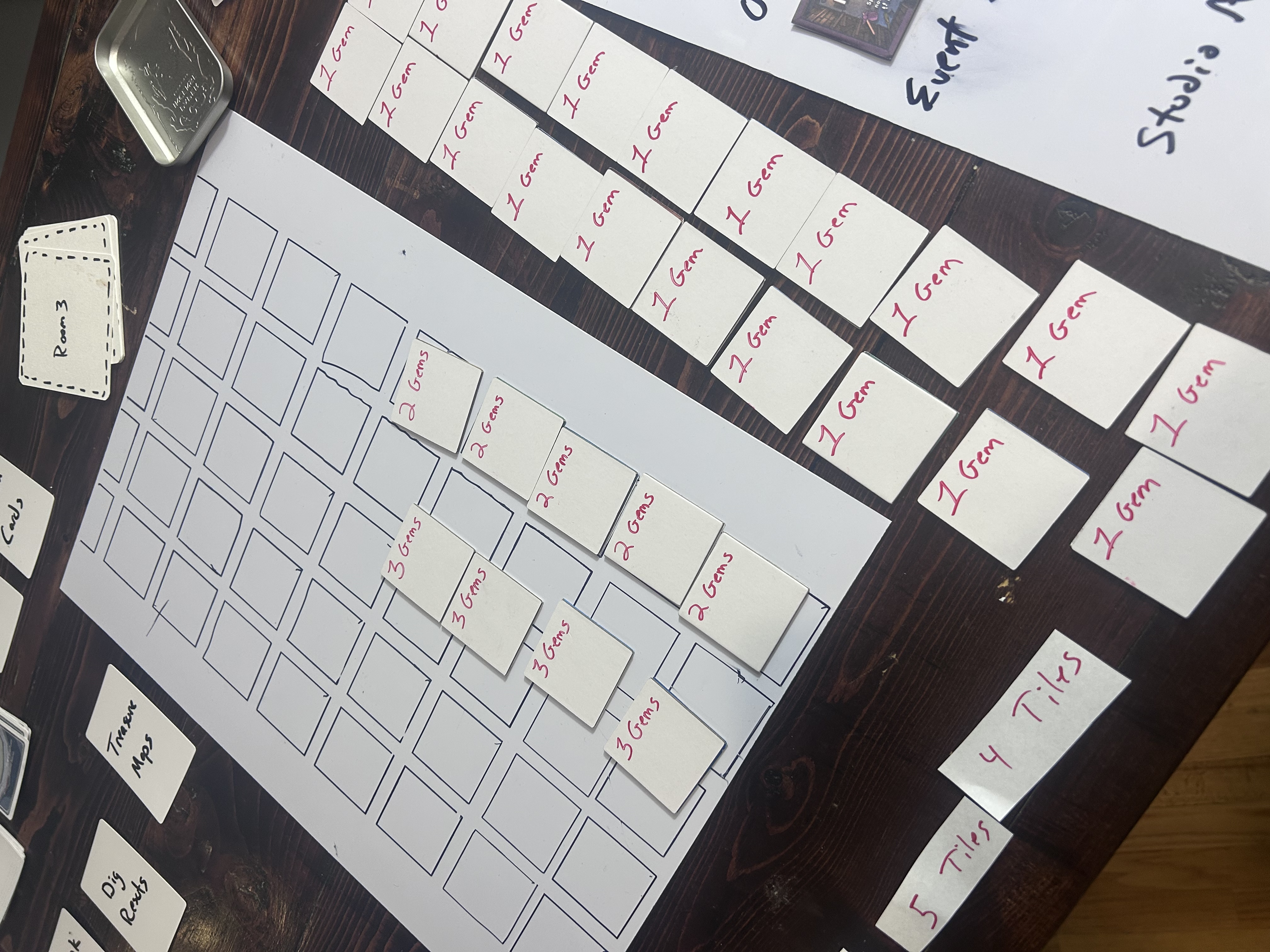 Prototype tile backs with gem costs and category letters